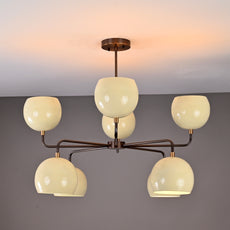 Stylish two-tier chandelier with eight cream glass globes and a brushed brass frame, perfect for contemporary living or dining spaces