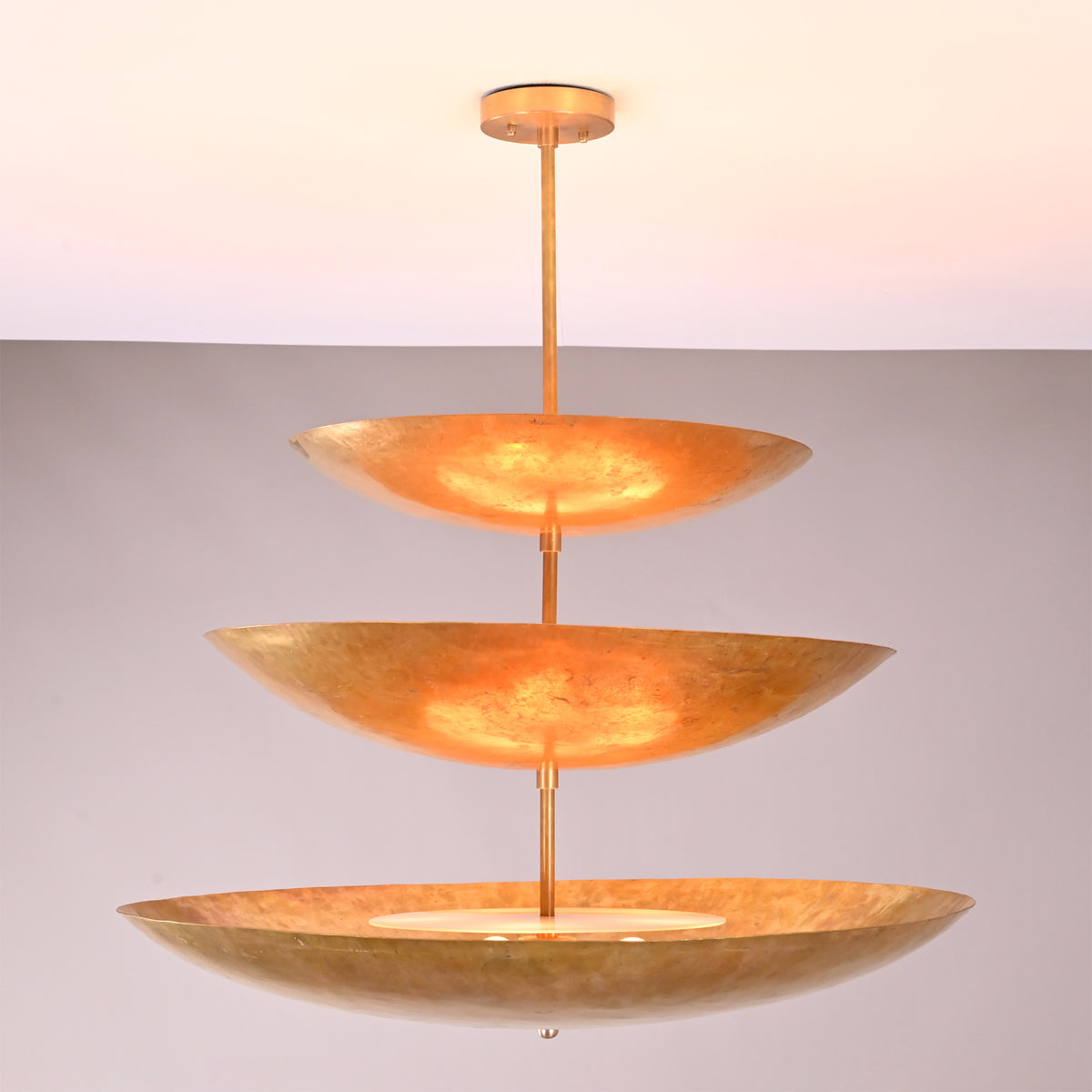 Front view of Celeste Triple Saucer Pendant Light with three stacked saucer shades and warm illumination.