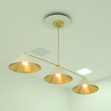 Angled view of Charleston 3-light chandelier featuring ivory cone shades, brass arms, and warm glowing bulbs.