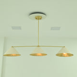 Front view of Charleston 48-inch linear chandelier featuring three evenly spaced ivory cone shades with warm interior lighting.