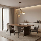 Charleston 4 light sculptural chandelier shown from the front with cream shades and warm bronze-tone branching arms.