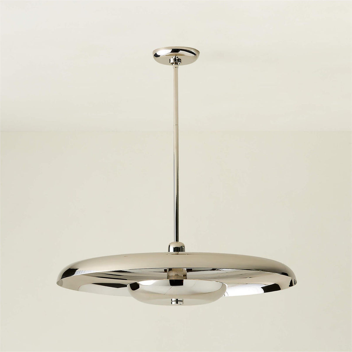Modern disc chandelier in polished chrome finish with minimalist silhouette and indirect lighting design.