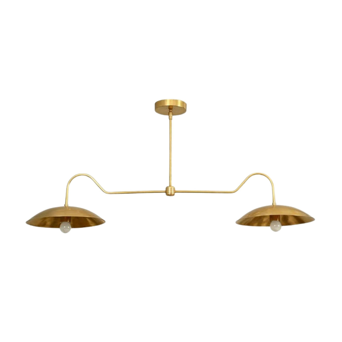 Cordoba 2 light chandelier featuring warm brass construction, curved linear arms, shallow dome shades and exposed bulbs.