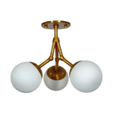 Cordoba 3 light Mid-Century Modern chandelier shown from the front with white opal globe shades, sculptural arms, and warm brass-tone finish.