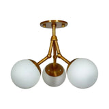 Cordoba 3 light sculptural chandelier shown from the front with three opal glass globes and branching brass-tone arms.