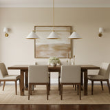 Corfu 3 light linear chandelier shown from the front with white cone shades and a slim brass frame.