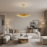 Crete 5 light brass fluted bowl chandelier shown from the front with a wide sculptural shade, slim suspension rod and round canopy.