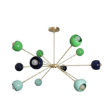 Crete 12 light multicolor Sputnik chandelier shown from an angled view featuring asymmetrical brass-tone arms and colorful spherical shades.