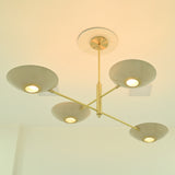 Angled underside view of Dallas 4-light chandelier showcasing sculptural brass arms, shallow bowl shades, and warm downward lighting.