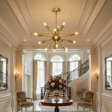 Dallas 12 light antique brass Sputnik chandelier shown from an angled view highlighting its sculptural starburst design and exposed bulbs.