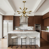 Dallas 12 light Mid-Century Sputnik chandelier shown illuminated with exposed bulbs, antique brass-tone arms, and a rounded central hub.