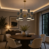 Delphi 12 light gray and brass Sputnik chandelier illuminated above a modern dining table in an elegant contemporary interior.