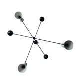 Bottom view of Dublin 6 light black and white sculptural chandelier featuring extended arms, rounded counterweights and geometric metal shades.