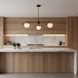 Underneath view of Eclipse 3 light disc globe chandelier with sculptural brass shades and white glass globes