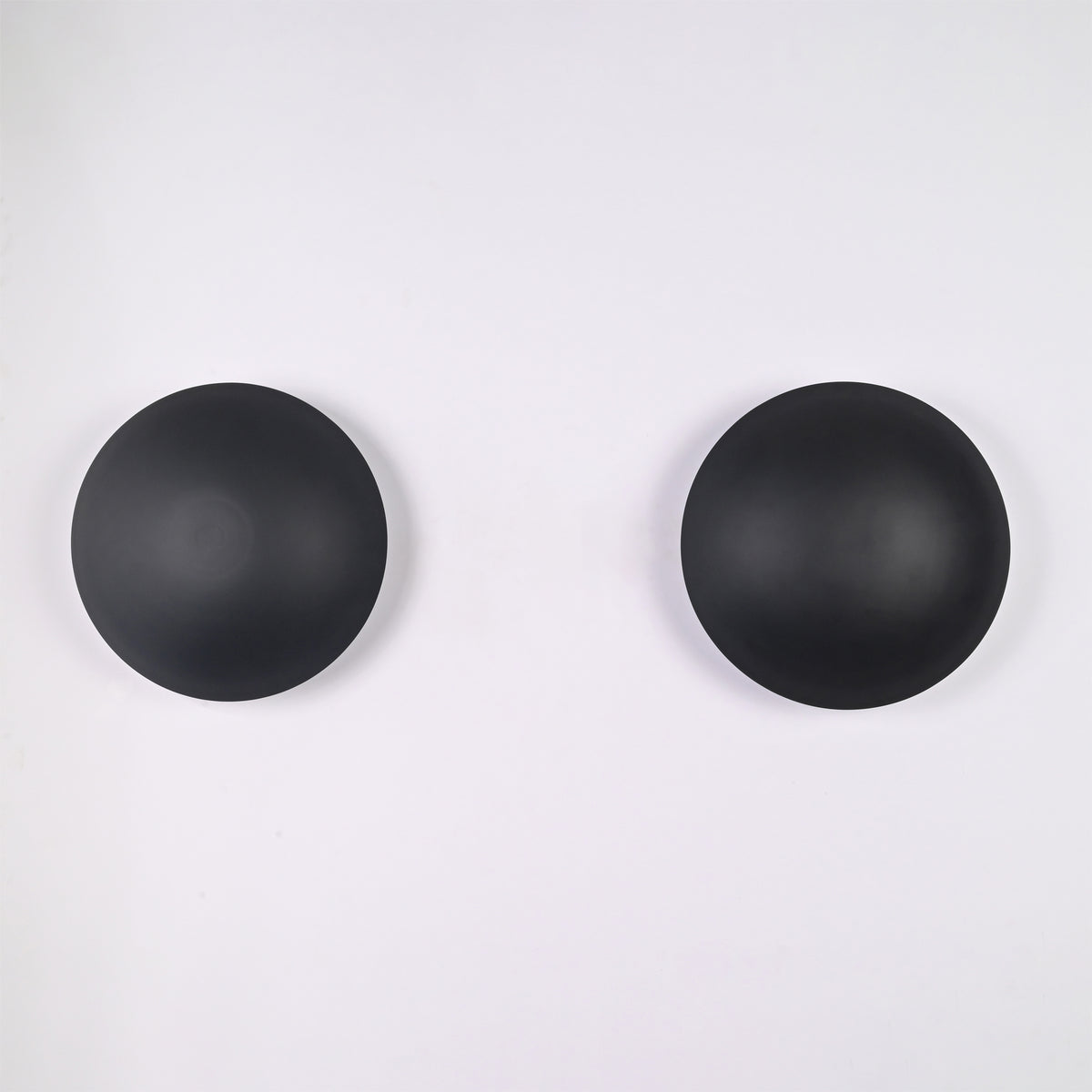 Front view of the Eclipse modern black dome wall sconce featuring a minimalist circular metal shade with a sleek matte black finish.