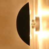 Side profile of the Eclipse black dome wall sconce showing its curved metal shade and concealed multi-light design.