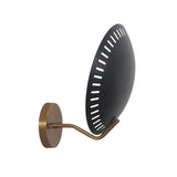 Side angled view of Eclipse perforated disc wall sconce featuring a large circular shade, curved brass arm and round canopy.