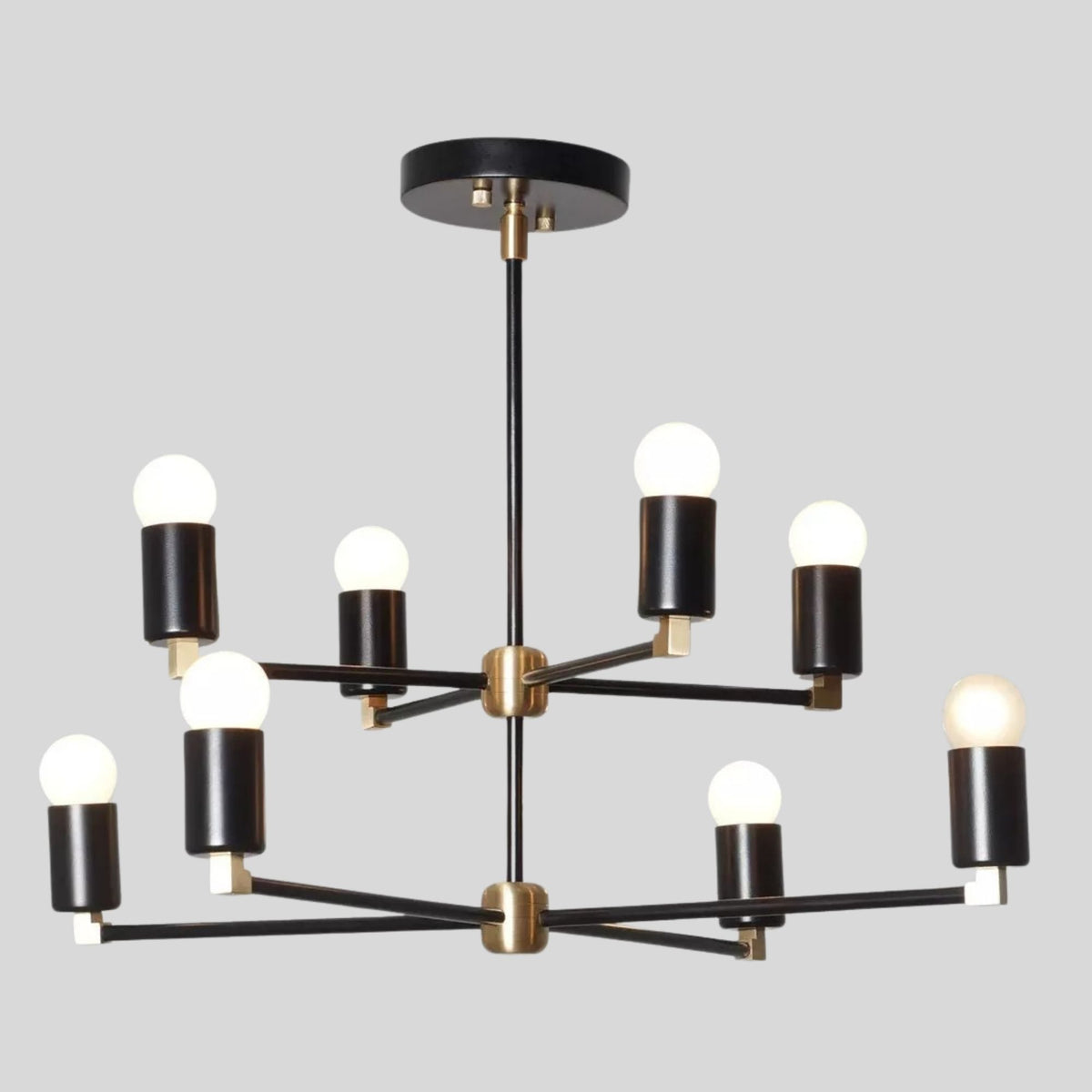 Angled view of the Edinburgh 8 light black and brass chandelier with geometric multi-arm construction and globe bulbs.