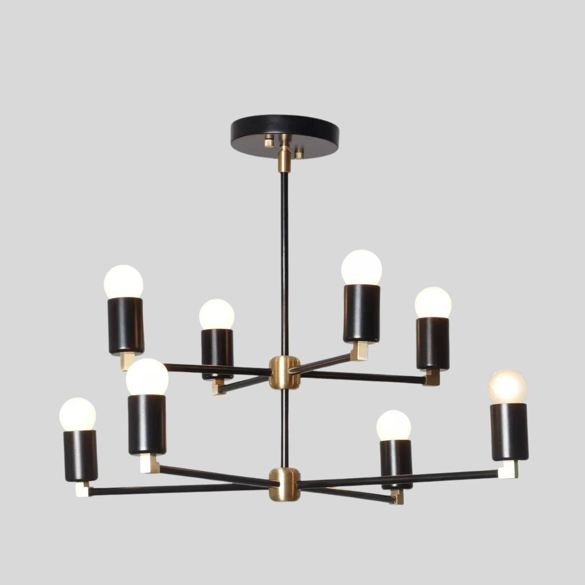 Edinburgh 8 light two-tier chandelier featuring black metal arms, brass-tone accents and exposed globe bulbs.