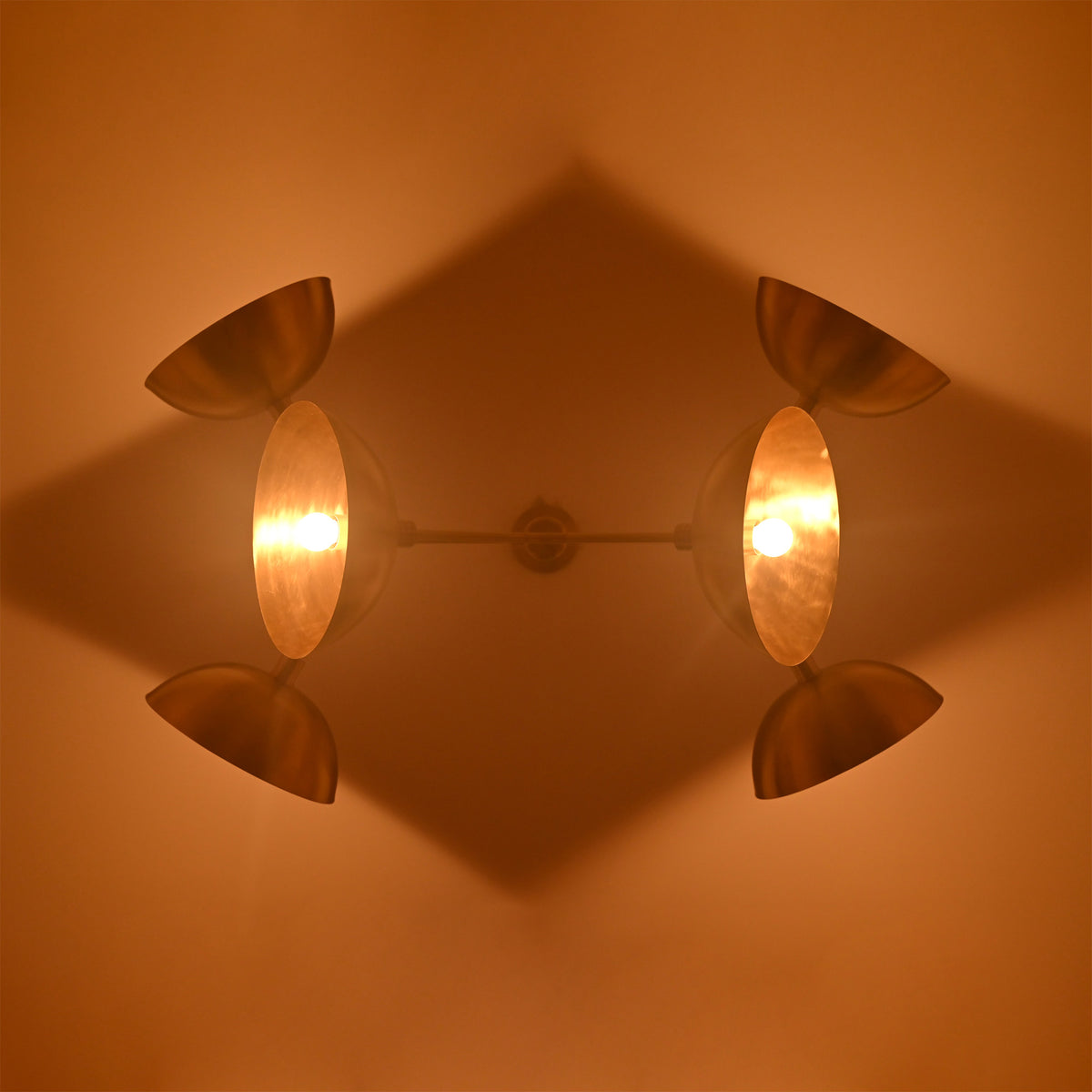 Florence Disc Orbital Chandelier ceiling view with four glowing disc shades and warm ambient light effect.