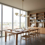 Florence 4 light sculptural bowl chandelier shown from an alternate angle with a minimalist linear brass-tone structure.