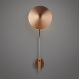 Front view of minimalist brass disc wall sconce with long stem and round backplate in brushed brass finish.