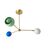 Geneva 3 light multicolor dome chandelier shown from an angled view with blue, mint green and white shades and a brass-tone frame.