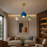 Geneva 3 light multicolor dome chandelier illuminated in a contemporary living room with blue, white and mint green shades.