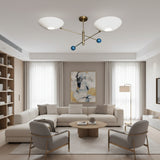 Geneva 2 light brass chandelier shown from an angled view with oversized white bowl shades and blue sphere accents.