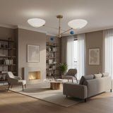 Geneva 2 light sculptural chandelier shown from the front with crossed brass arms, white bowl shades and blue decorative accents.