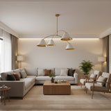 Genoa 4 light chandelier shown from an angled view with asymmetrical curved brass-tone arms and white tapered cone shades.