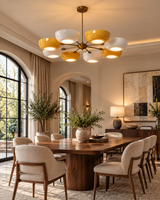 Genoa 8-light yellow and white bowl chandelier illuminating an elegant dining room with a walnut table, cream upholstered chairs, and warm ambient lighting.
