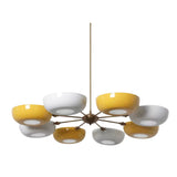 Genoa 8-light sculptural chandelier featuring glossy yellow and white rounded bowl shades arranged around a central brass-tone hub.