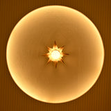 Gold eight-point starburst wall sconce glowing warmly inside a circular architectural wall niche with textured finish.