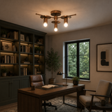 Granada 3 light bronze-tone sculptural disc chandelier illuminated on the ceiling of a warm contemporary home office.