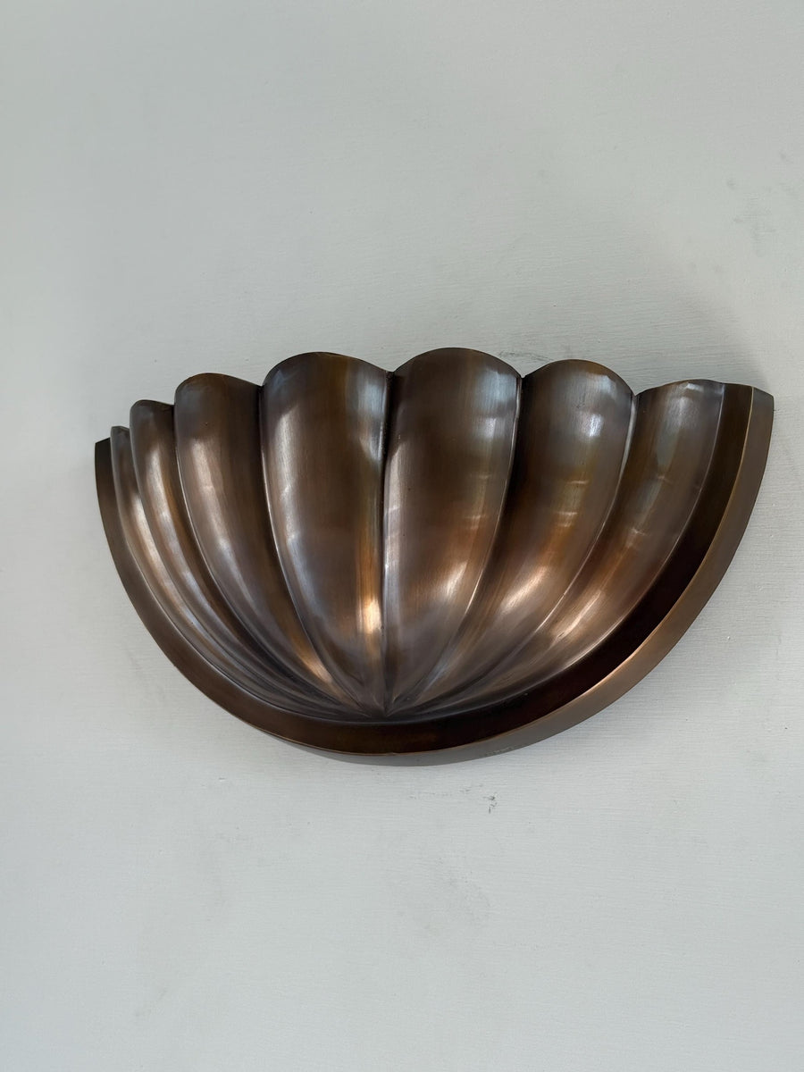 Brass Leaf Studio half-flower wall sconce in dark bronze/brass finish with fluted scallop bowl shade, front view on white background.