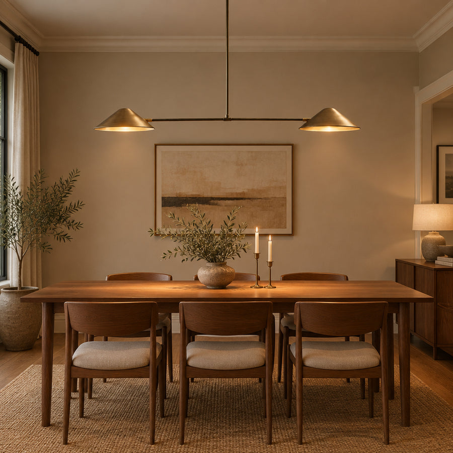 Hamburg 2 light linear chandelier shown from the front with symmetrical brass cone shades and long central downrod.