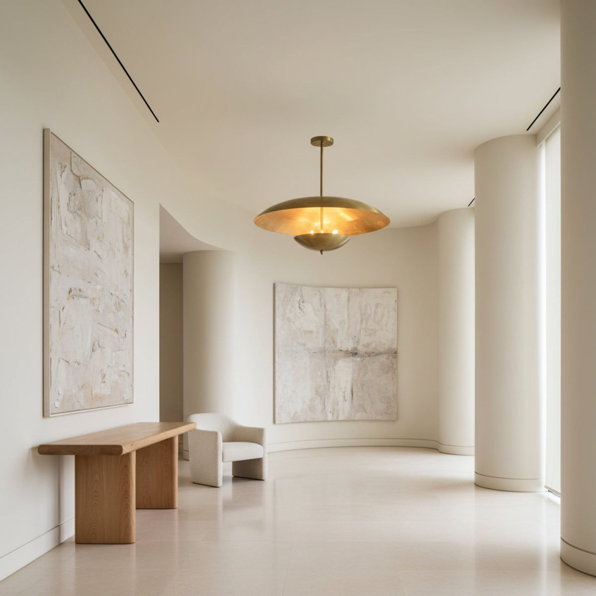 Hamptons 3 light brass-tone dome chandelier shown illuminated with warm ambient light reflecting beneath the sculptural shade.