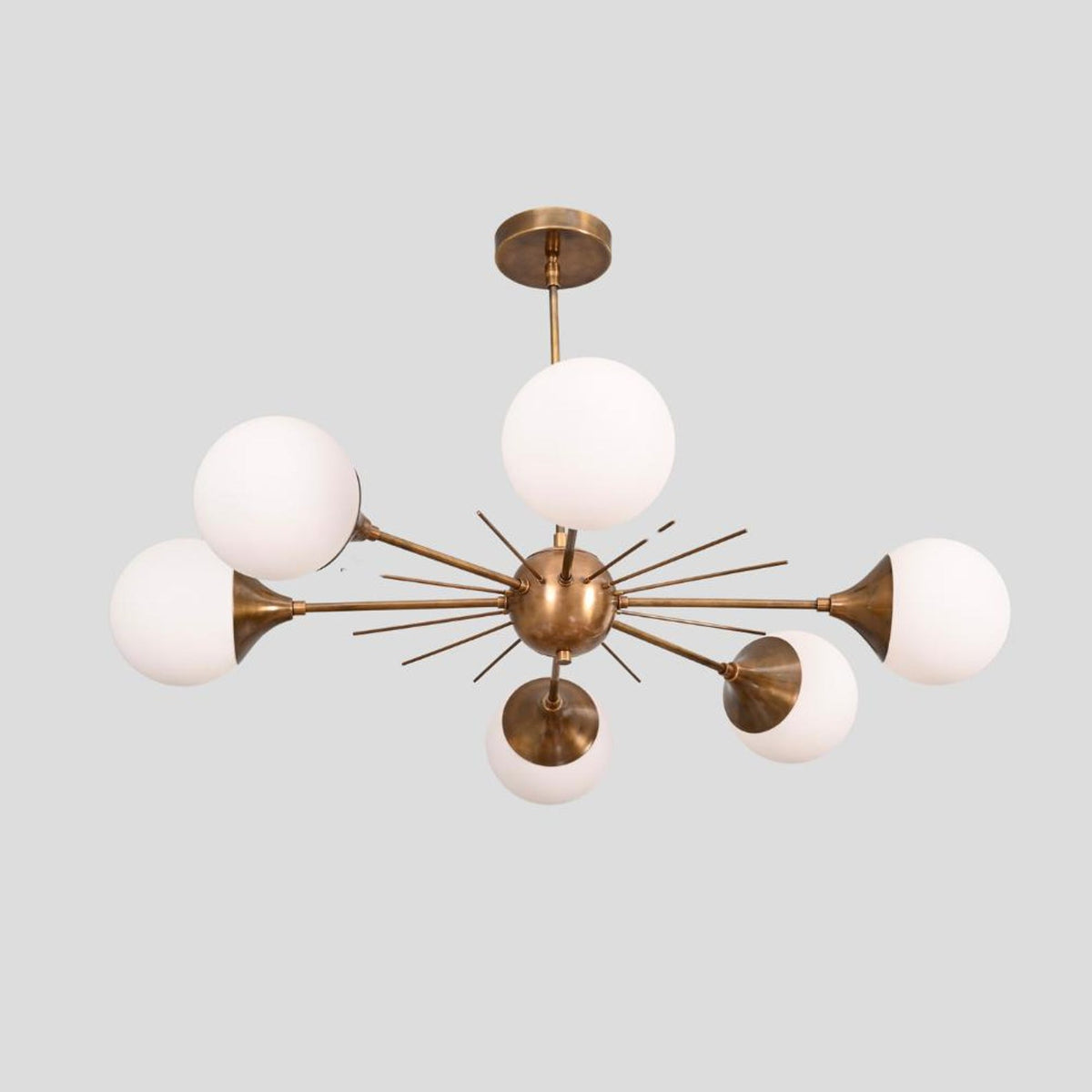 Stylish Sputnik brass chandelier with six frosted globe glass shades and brushed brass finish, ideal for living rooms, bedrooms, and dining areas.