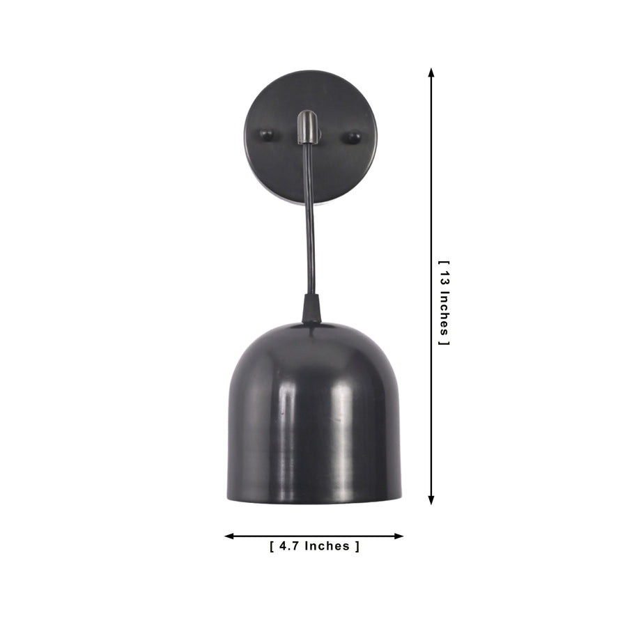 Harlow modern black dome wall sconce installed in a contemporary kitchen creating warm task and ambient lighting.