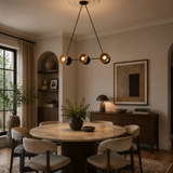 Helsinki 6 light chandelier close-up highlighting the sculptural double disc shades, black finish and warm brass interiors.