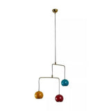 Helsinki 3 light sculptural mobile pendant with teal, mustard yellow and red rounded metal shades suspended from an asymmetrical brass-tone frame.