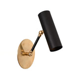 Hudson adjustable cylinder wall sconce with matte black cylindrical shade, solid brass backplate, and adjustable dual-joint arm shown in angled front view.