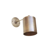 Bottom perspective view of the Hudson adjustable cylinder wall sconce highlighting the handcrafted cylindrical shade, open light source, adjustable arm, and premium brass finish.
