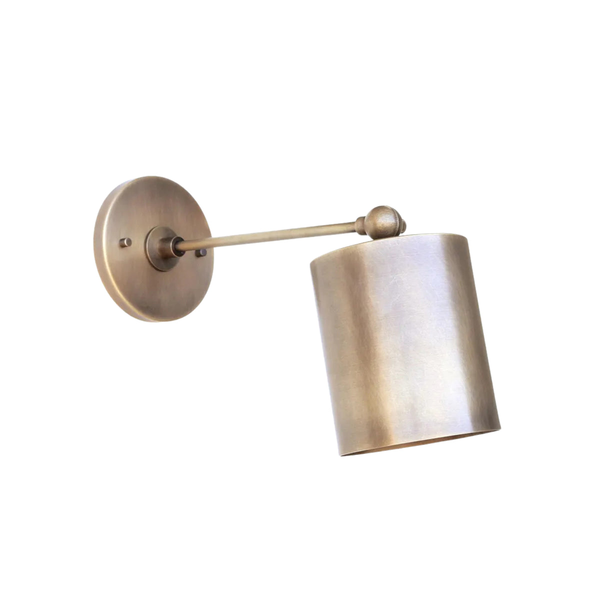 Side angle view of the Hudson adjustable cylinder wall sconce with slim brass arm, pivoting ball-joint detail, and handcrafted cylindrical metal shade.