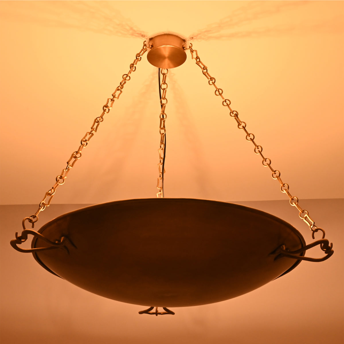 Warm ambient lighting view of the Hudson Artisan Bowl Chandelier creating soft indirect ceiling illumination with an elegant suspended bowl.