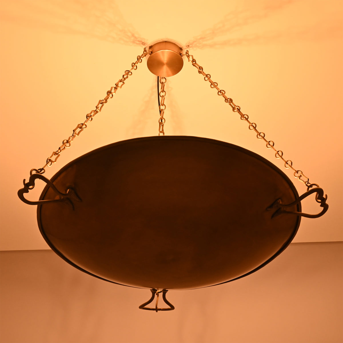 Illuminated underside of the Hudson Artisan Bowl Chandelier highlighting the handcrafted bowl and soft upward ambient lighting.