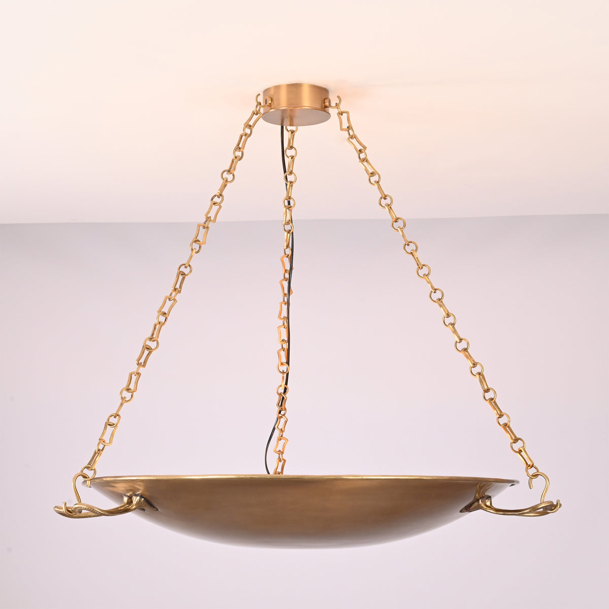 Illuminated front view of the Hudson Artisan Bowl Chandelier showcasing warm ambient uplighting, artisan branch accents, and suspended bowl design.