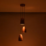 Hudson Cascading Cone Cluster Pendant Light in a dark setting highlighting warm ambient illumination from handcrafted copper cone shades.