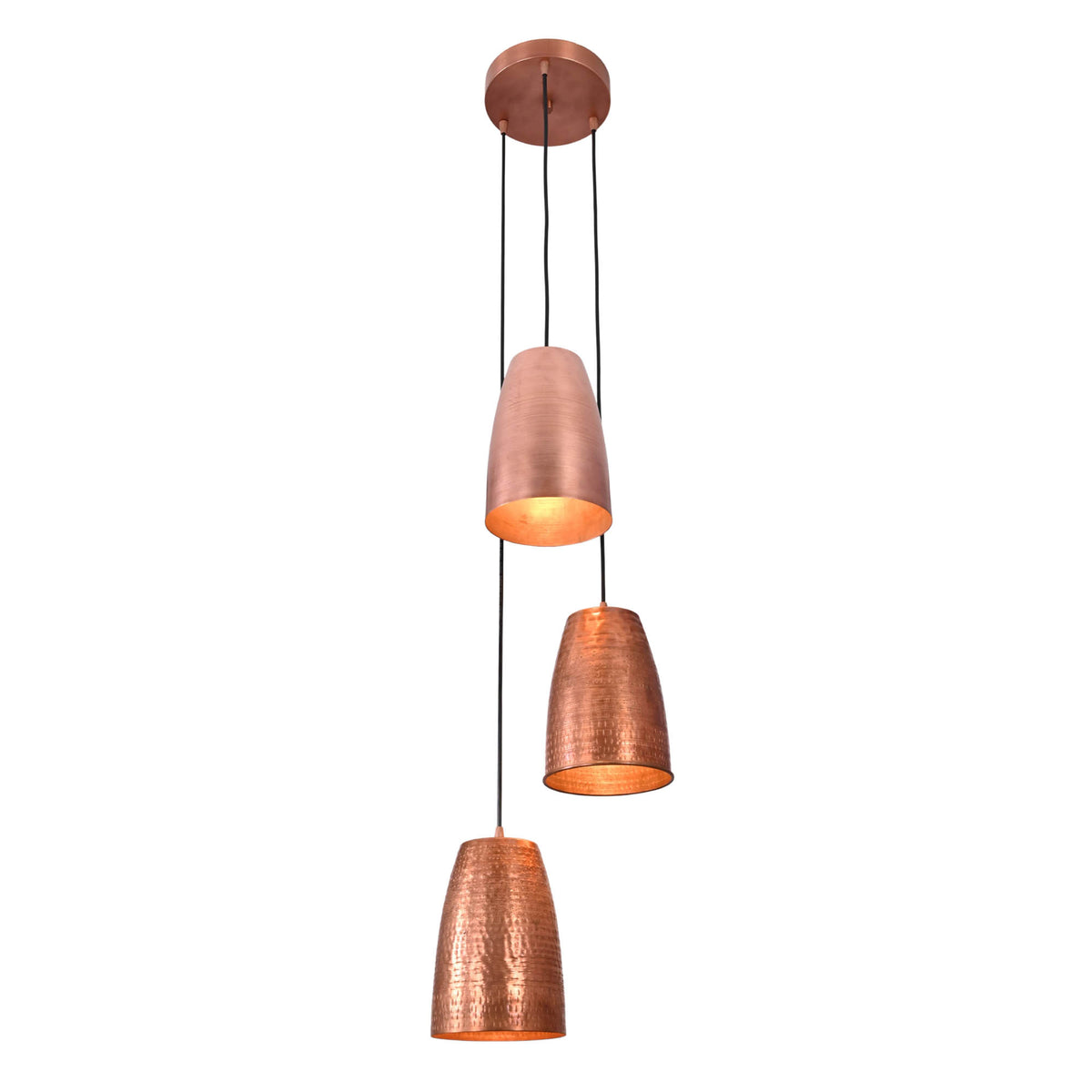 Perspective view of the Hudson Cascading Cone Cluster Pendant Light with three suspended copper cone pendants casting a warm ambient glow.
